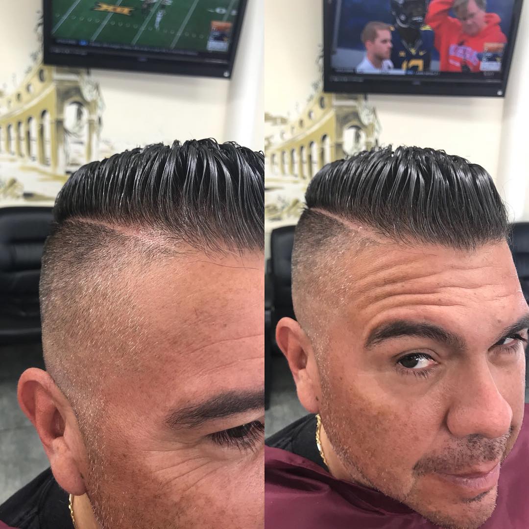 Slicked back pompadour with high fade